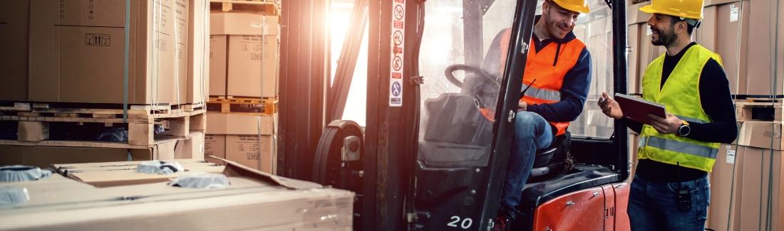 two men working on forklift