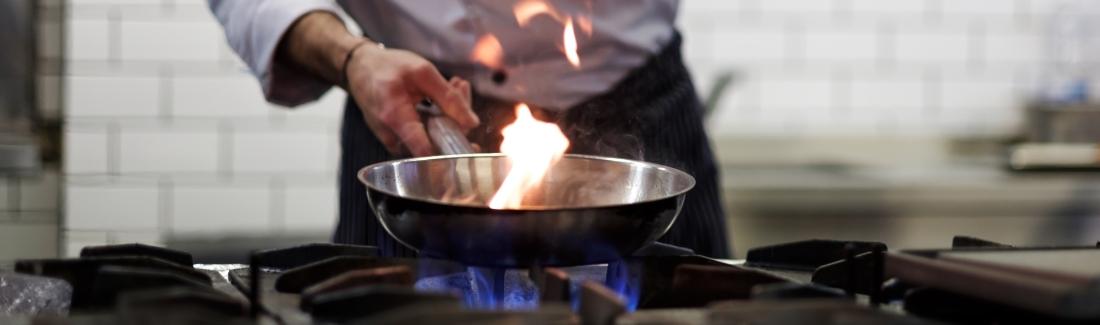 Man frying over gas hob